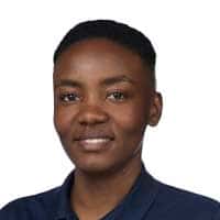 Fridah Muthoni, with short hair, is smiling slightly while wearing a dark collared shirt and is posed against a plain white background.